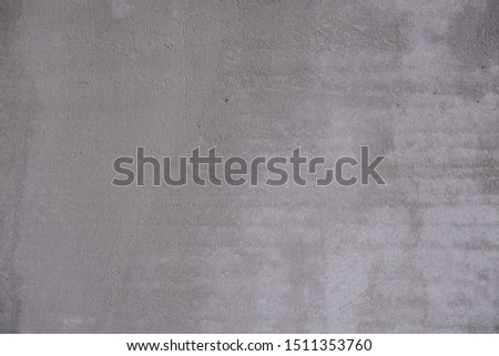 Abstract gray background. Rough concrete wall covered with cement.