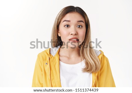 Yikes girl in trouble. Worried nervous young cute asian blond girl smirking anxious confused panicking unknow what do made mistake frowning uncertain apologizing huge fault work Royalty-Free Stock Photo #1511374439