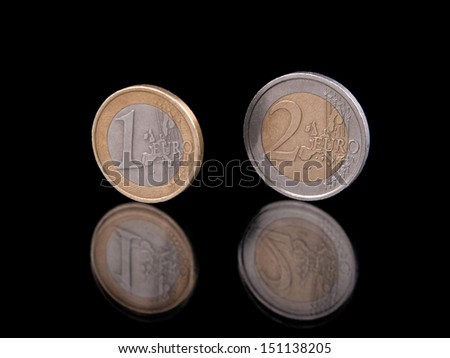 Euro coins standing on black