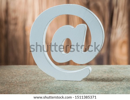 white ceramic email symbol on vintage wood background
