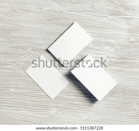 Photo of blank white business cards on light wooden background. Copy space for text. Flat lay.