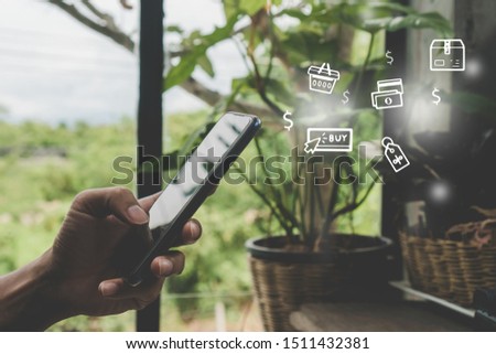 Women hand using smartphone do online selling for people shopping online in black friday with chat box, cart, dollar icons pop up in cafe shop background. Social media maketing concept.