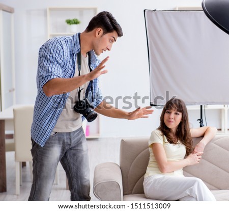 Young photographer working in photo studio