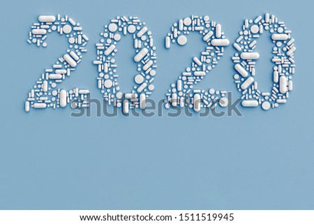 pills scattered on a blue background in the form of figures 2020. 3D illustration