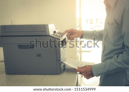 Bussiness man  hand press button on panel of printer