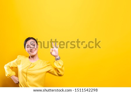 Happy woman showing OK gesture isolated on background