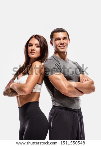 Portrait of two young fit sporty people with crossed hands Royalty-Free Stock Photo #1511550548