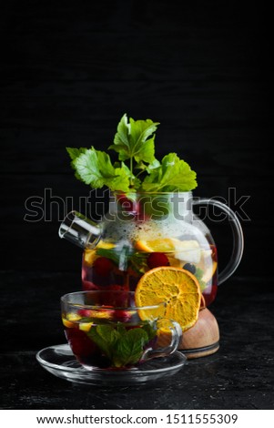 Forest berry and fruit tea. Hot winter drinks. On a black background. Top view.