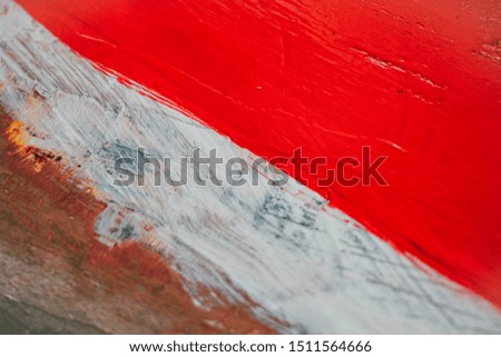 An image of the color symbol of the Indonesian flag painted on a piece of wood