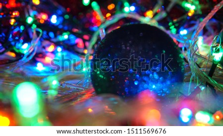 Christmas colorful New Year's Bokeh neon lights. Abstract Blurred photo background with blinking lights from garlands and balls. Decoration with bright colored neon pink blue green flickering lights