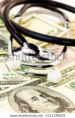 Stethoscope on some money - medical expenses