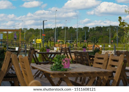 Outdoor cafe. Wooden tables and chairs. Beautiful design. Summer beautiful background