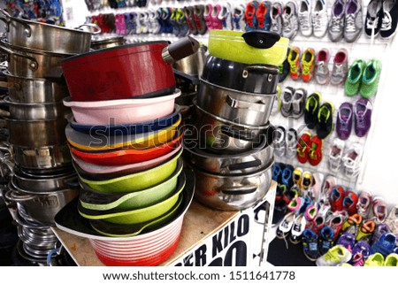 Photo of stack of assorted colorful ceramic and steel cooking pans