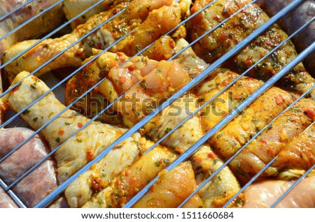 Marinated chicken legs on hot BBQ charcoal field grill