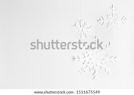 background with hanging paper snowflakes, homemade, free space for your text