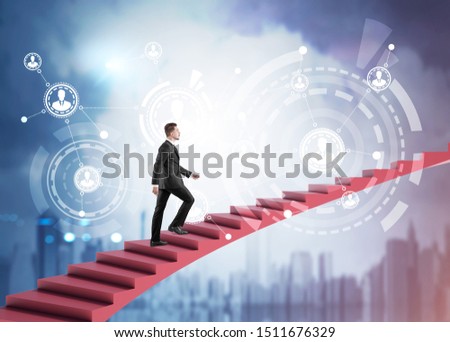 Young businessman climbing stairs to sky over blurry cityscape background with HUD people network interface. Concept of HR and hi tech. Toned image double exposure