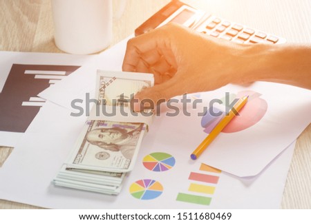 Hand of worker holding money ,finance and accounting concept.