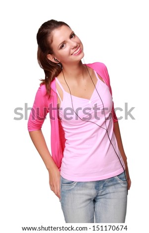 Cheerful girl in bright clothes and headphones listening to music and having fun