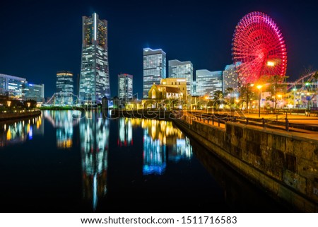 Asia business concept for real estate and corporate construction - panoramic modern city skyline looking up view under blue night sky in Yokohama, Japan