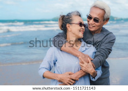 Happy asian couple senior eldely retirement resting at beach honeymoon family together happiness people lifestyle, copy space the left Royalty-Free Stock Photo #1511721143