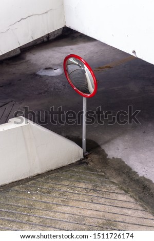 Convex mirror on a metal pole at the entrance to the car for safety