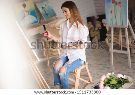 girl focusing on art canvas while painting