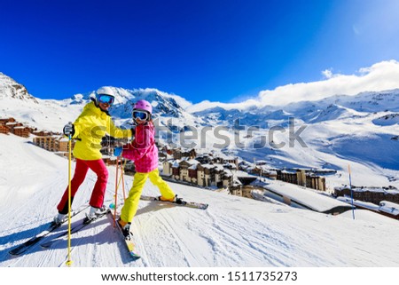 Happy family enjoying winter vacations in mountains, Val Thorens, 3 Valleys, France. Playing with snow and sun in high mountains. Winter holidays. Royalty-Free Stock Photo #1511735273