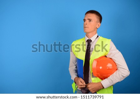 successful business builder engineer with hard hat documents on blue background