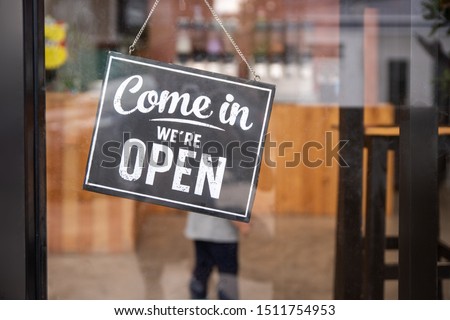 Coffee shop sign. come in we're open.