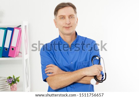 Portrait of mature, doctor posing in medical office, medical insurance