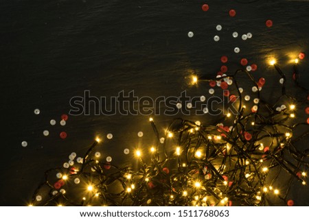 Christmas Warm Light on Natural Stone Background Top View with Copyspace. Beautiful Garland Lights Texture or New Year Pattern for Xmas Design