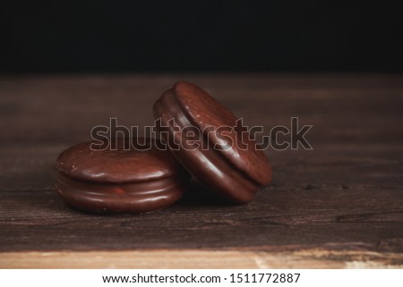 Chocolate chip cookies on a dark wooden table. Background image. Tasty breakfast.