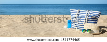 Stylish beach accessories on sandy sea shore. Banner design 