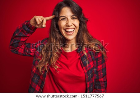 Young beautiful woman wearing casual jacket standing over red isolated background clueless and confused with open arms, no idea concept.