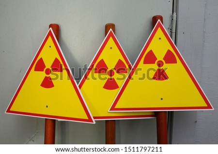 Radiation hazard signs on sticks placed against the wall