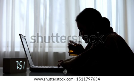 Ill female freelancer working on laptop early in morning and drinking tea
