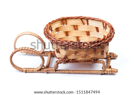 Wicker basket in the form of a sleigh isolated on white background