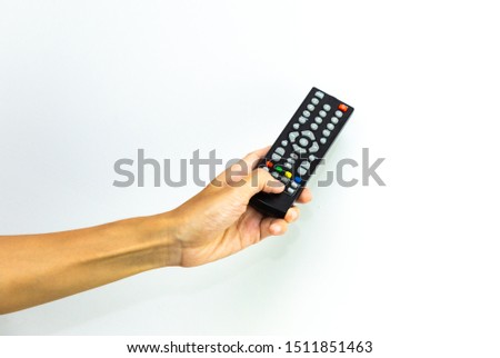 remote control   hold up isolated on white background.  Arm pressing button remote control of TV for changing  channel.
