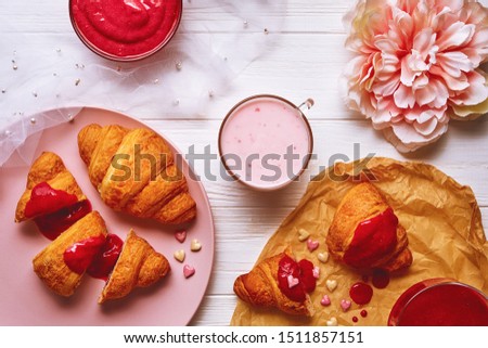 Flat lay picture of sweet croissants breakfast with strawberry jam 