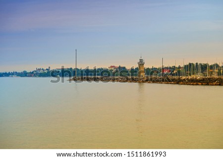 View of lighthouse and panorama of Desenzano in the province of Brescia, in Lombardy, Italy, on the southwestern shore of Lake Garda.