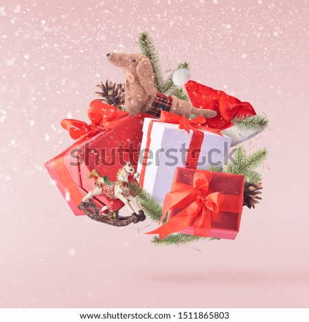Christmas card conception. Christmas bauble and decoration falling in the air on pink background. Levitation concept.High resolution image