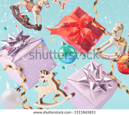 Christmas card conception. Christmas bauble and decoration falling in the air on turquoise background. Levitation concept.High resolution image