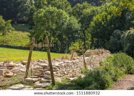 A Cotswold dry stone wall in the process of being built. A traditional countryside craftsman's skill Royalty-Free Stock Photo #1511880932