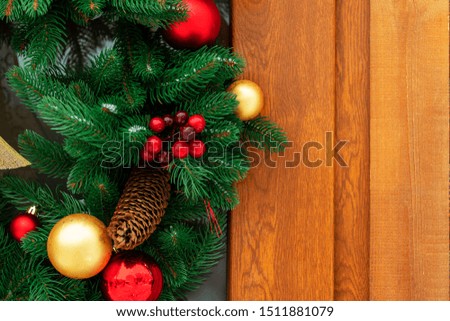 Christmas wooden background. 
Christmas decoration with fir branches and red, yellow  berries on a background. Striped Timber Desk Close Up, Brown Boards. Top view with copy space