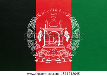 Afghanistan national fabric flag, textile background. Symbol of international asian world country. Afghan state official sign.
