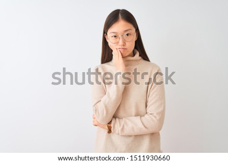 Young chinese woman wearing turtleneck sweater and glasses over isolated white background thinking looking tired and bored with depression problems with crossed arms.