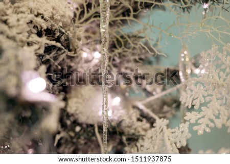 Beautiful Christmas tree with white artificial snow on branches and decorations.