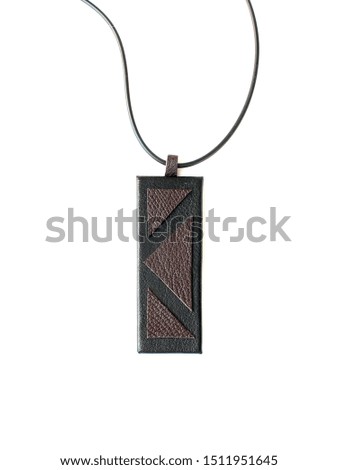 Leather pendant on white background. Handmade