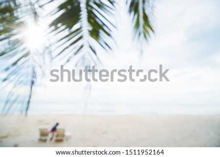 Abstract soft blur nature tropical beach with green coconut palm leaf and light wave bokeh background concept for blurry sky summer landscape water and sand, holiday ocean travel, relax vacation day