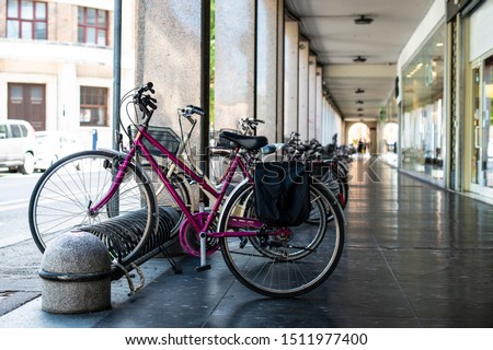 Bikes mounted on a bicycle stand on italian street. 